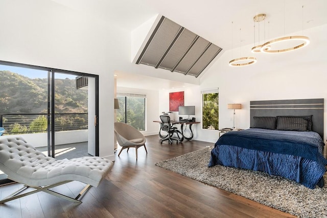 bedroom with high vaulted ceiling, dark hardwood / wood-style flooring, and multiple windows