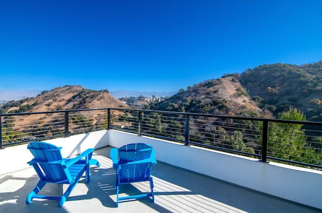 balcony featuring a mountain view