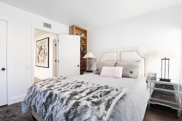 bedroom with dark wood-type flooring