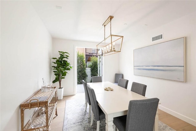 dining room featuring a chandelier and light hardwood / wood-style floors