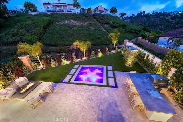 view of pool with a patio area, a yard, and area for grilling