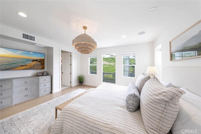 bedroom featuring light hardwood / wood-style floors and access to exterior