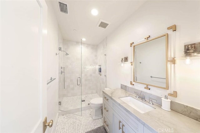 bathroom with vanity, toilet, walk in shower, and tile patterned flooring