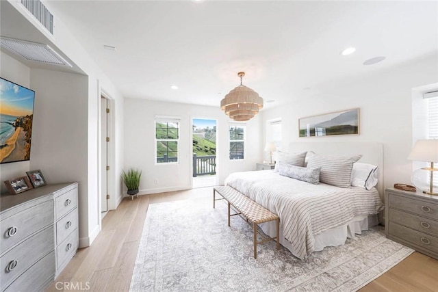 bedroom featuring light hardwood / wood-style floors and access to outside