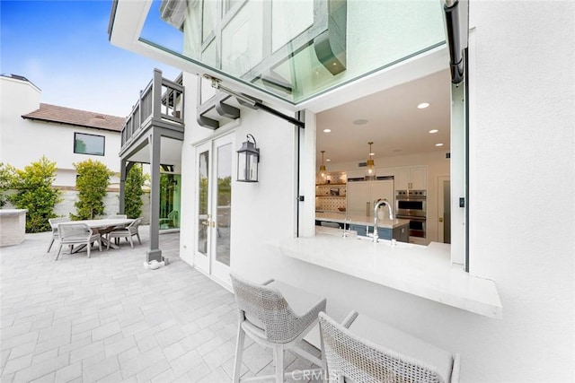 view of patio with sink and french doors