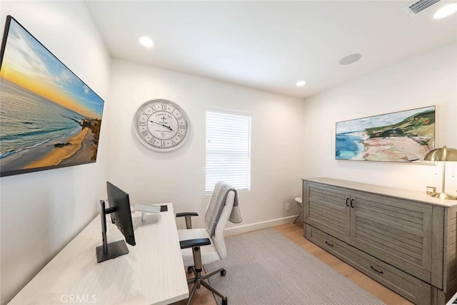 home office with light hardwood / wood-style floors