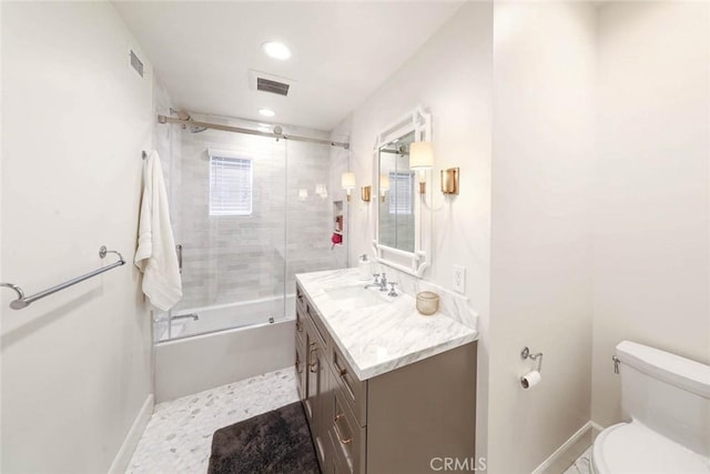 full bathroom with bath / shower combo with glass door, toilet, and vanity