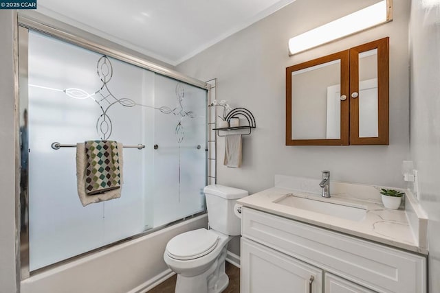 full bathroom featuring bath / shower combo with glass door, toilet, and vanity