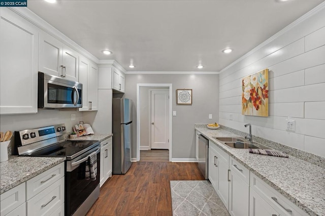 kitchen featuring white cabinetry, ornamental molding, appliances with stainless steel finishes, and dark hardwood / wood-style flooring