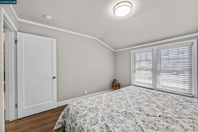 bedroom with ornamental molding, dark hardwood / wood-style flooring, and lofted ceiling