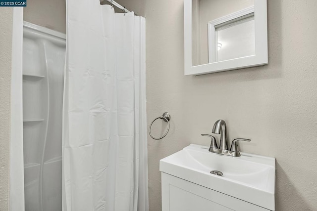 bathroom featuring vanity and a shower with curtain