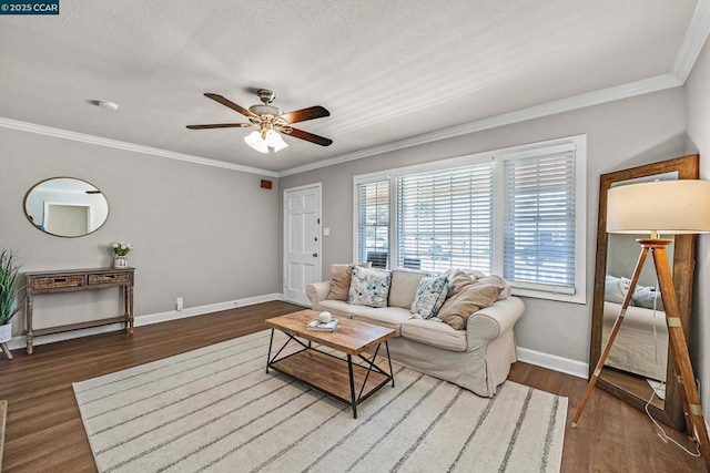 living room with hardwood / wood-style flooring, ornamental molding, and ceiling fan