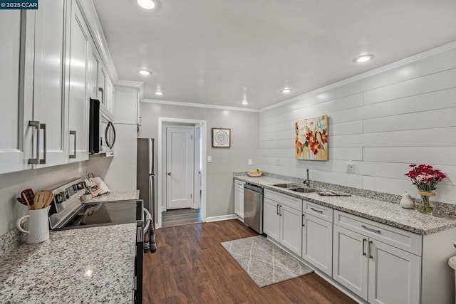 kitchen with light stone countertops, white cabinets, appliances with stainless steel finishes, and sink