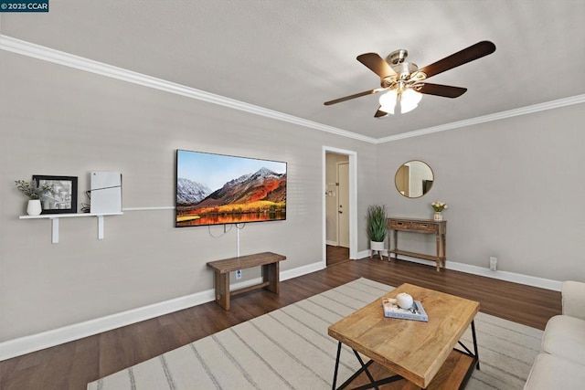 living room featuring ceiling fan, dark wood-type flooring, and ornamental molding