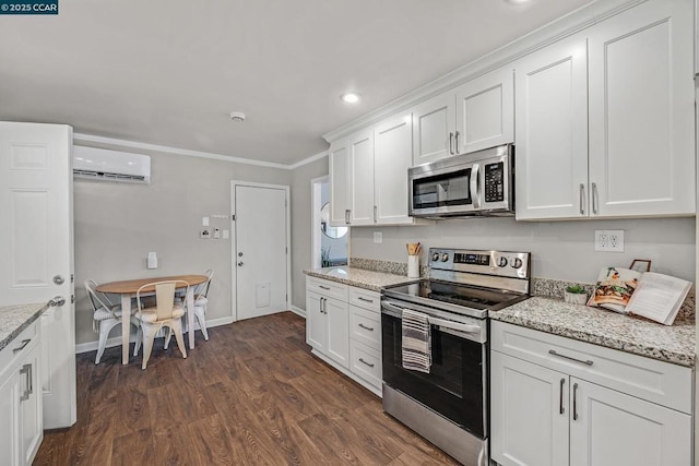 kitchen with light stone countertops, white cabinetry, an AC wall unit, dark hardwood / wood-style flooring, and stainless steel appliances