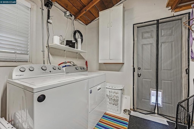 washroom with washer and dryer, wooden ceiling, and cabinets