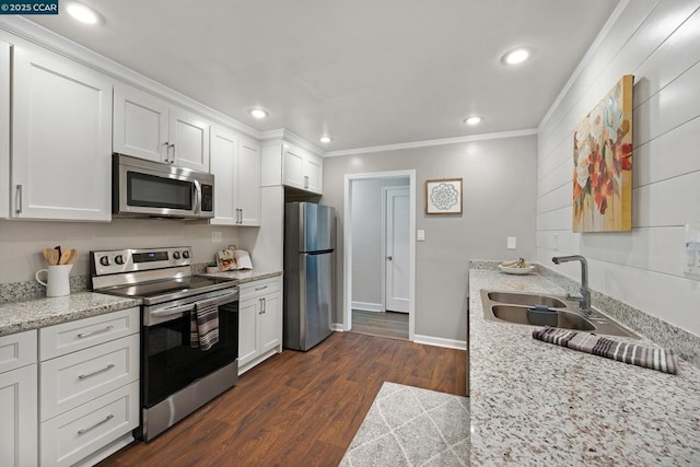 kitchen featuring white cabinets, dark hardwood / wood-style floors, light stone countertops, and stainless steel appliances