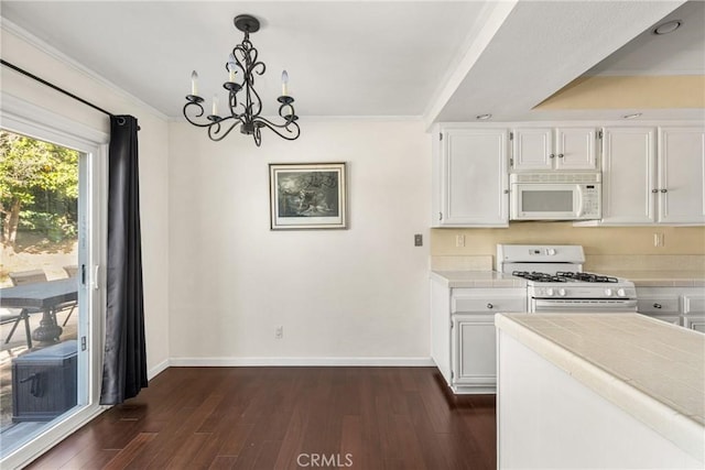 kitchen featuring dark hardwood / wood-style floors, white cabinets, white appliances, and decorative light fixtures