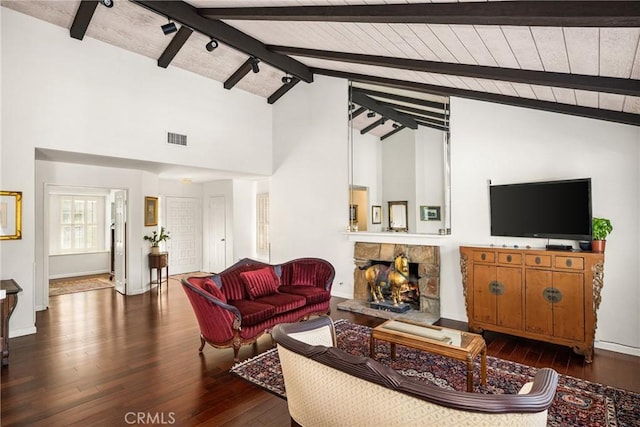 living room featuring a stone fireplace, high vaulted ceiling, dark hardwood / wood-style flooring, wooden ceiling, and beam ceiling