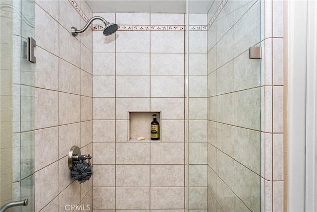 bathroom featuring a shower with shower door