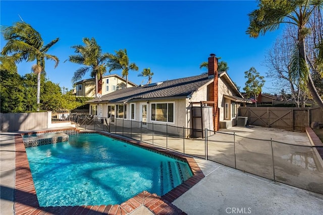 view of pool featuring cooling unit and a patio area