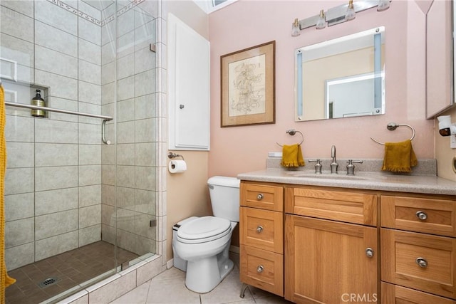 bathroom with tile patterned flooring, vanity, a shower with shower door, and toilet