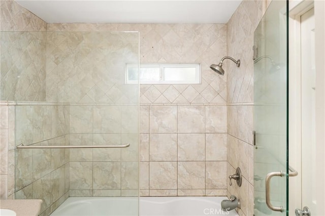 bathroom with vanity and bath / shower combo with glass door