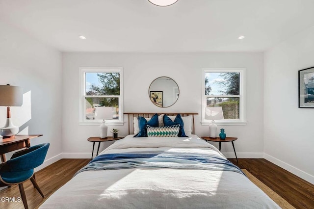 bedroom with dark wood-type flooring