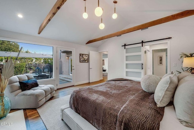 bedroom featuring hardwood / wood-style flooring, access to outside, a barn door, and lofted ceiling with beams