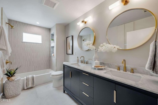 full bathroom with toilet, vanity, and tiled shower / bath