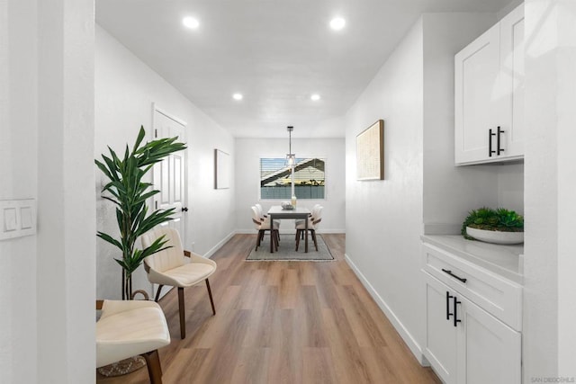 corridor with light hardwood / wood-style flooring