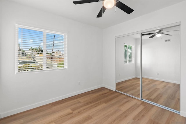 unfurnished bedroom with a closet, ceiling fan, and hardwood / wood-style flooring