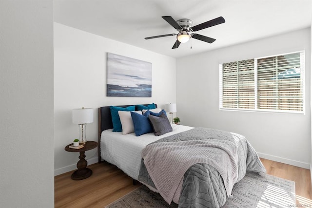 bedroom with ceiling fan and hardwood / wood-style floors