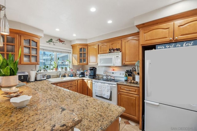 kitchen featuring pendant lighting, sink, light stone counters, light tile patterned flooring, and white appliances