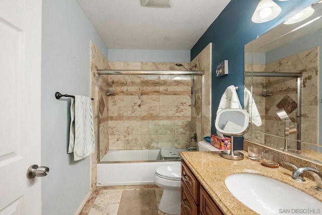 full bathroom with enclosed tub / shower combo, vanity, and toilet