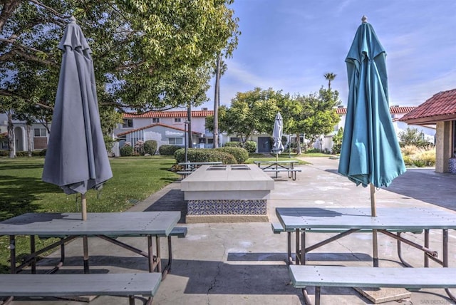 view of community with a lawn and a patio