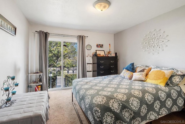 bedroom with carpet and access to outside