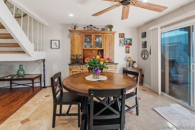 tiled dining area featuring ceiling fan