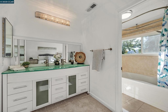 bathroom with vanity, a tub, and tile patterned floors