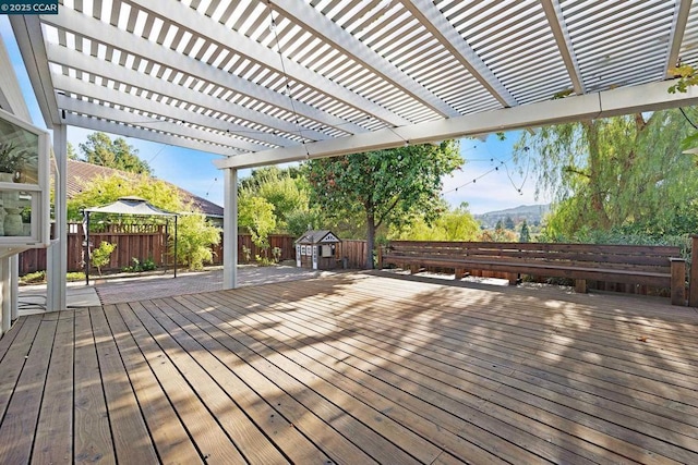 deck featuring a mountain view and a pergola