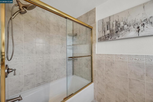 bathroom featuring combined bath / shower with glass door