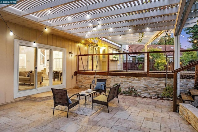 patio terrace at dusk with an outdoor living space and a pergola