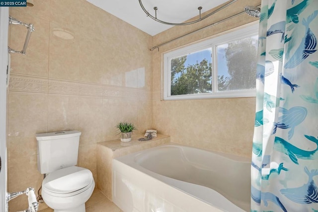 bathroom featuring toilet, tile walls, shower / bath combo with shower curtain, and tile patterned flooring