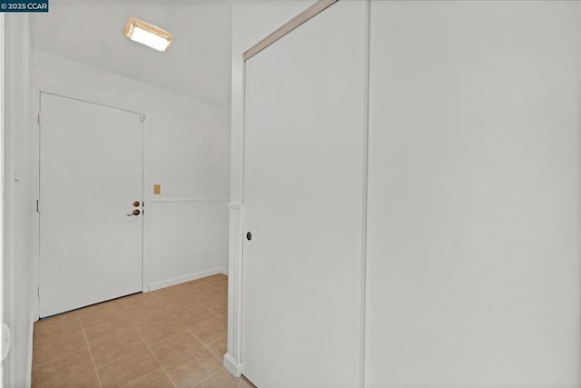 hall featuring light tile patterned floors