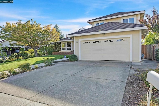 view of front facade with a garage and a front lawn