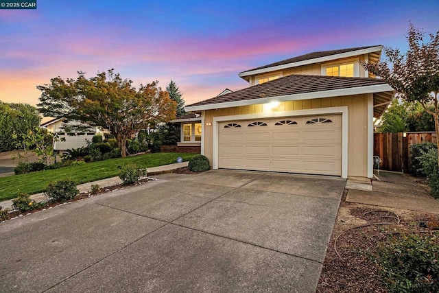 view of front of property featuring a garage and a yard