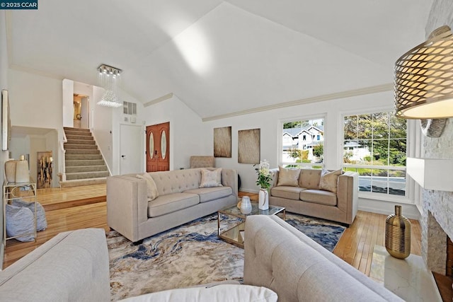 living room with high vaulted ceiling and hardwood / wood-style floors