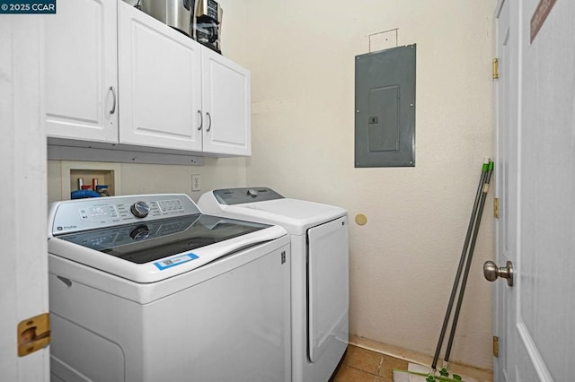 washroom with washer and dryer, cabinets, electric panel, and tile patterned flooring