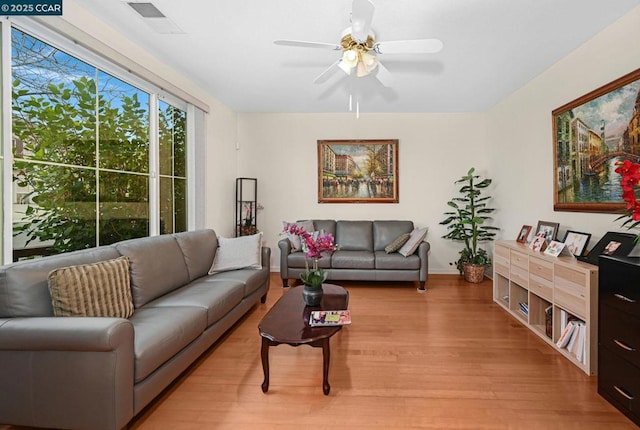 living room featuring light hardwood / wood-style floors and ceiling fan