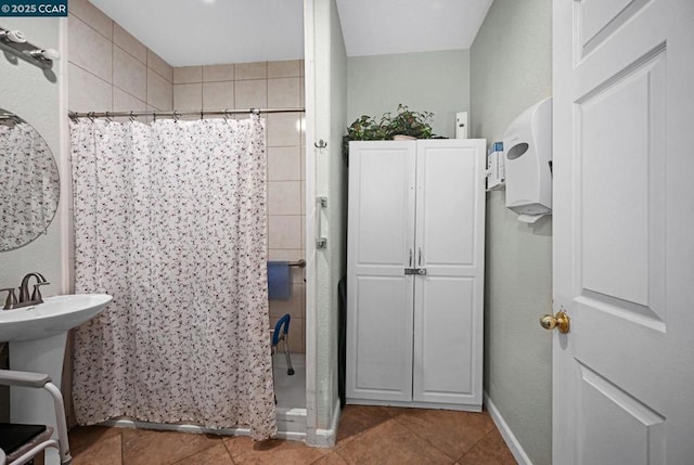 bathroom featuring curtained shower, tile patterned floors, and sink